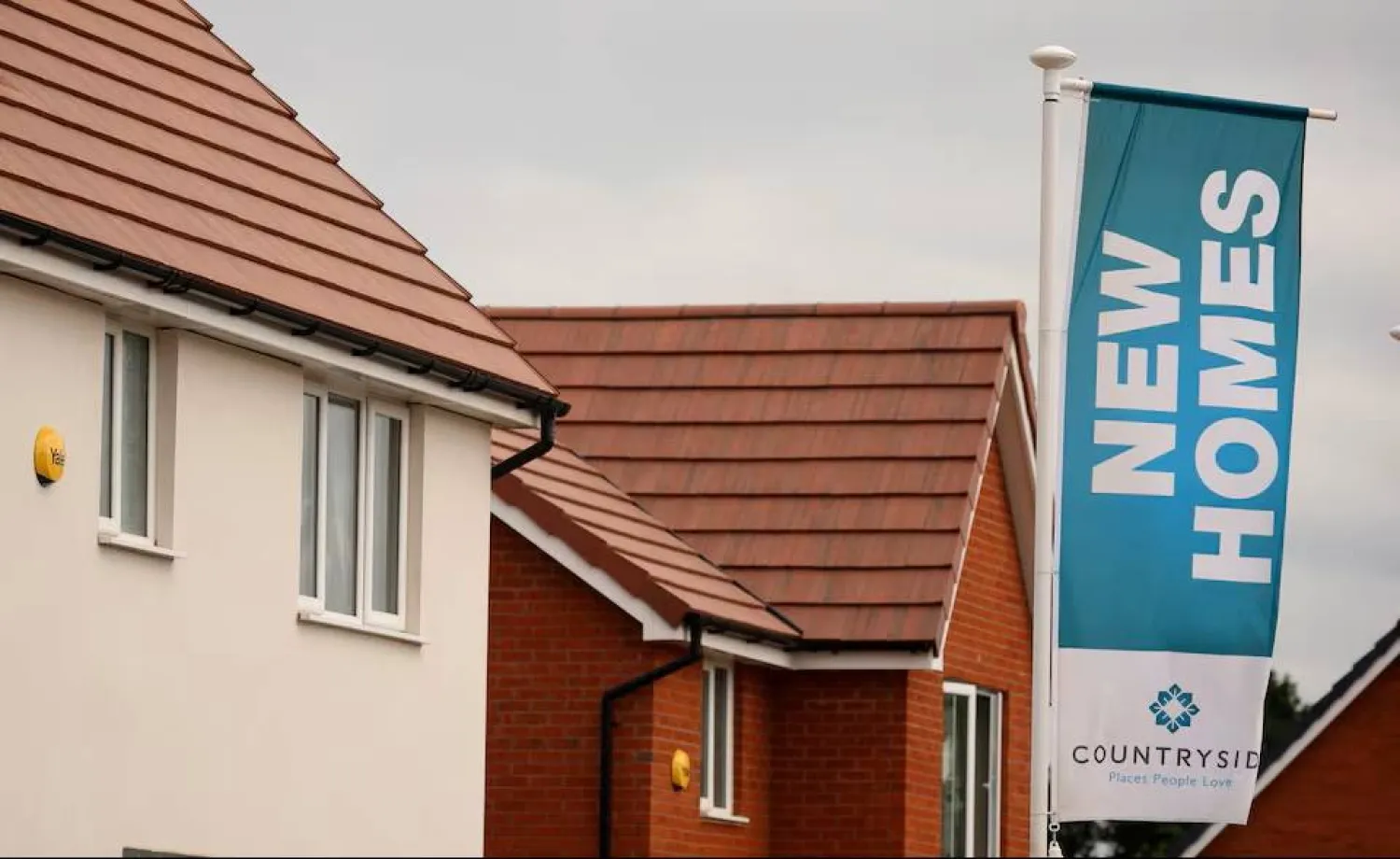 A banner advertising new houses for sale a seen on a new housing development under construction in Partington, Britain June 1, 2023. REUTERS/Phil Noble