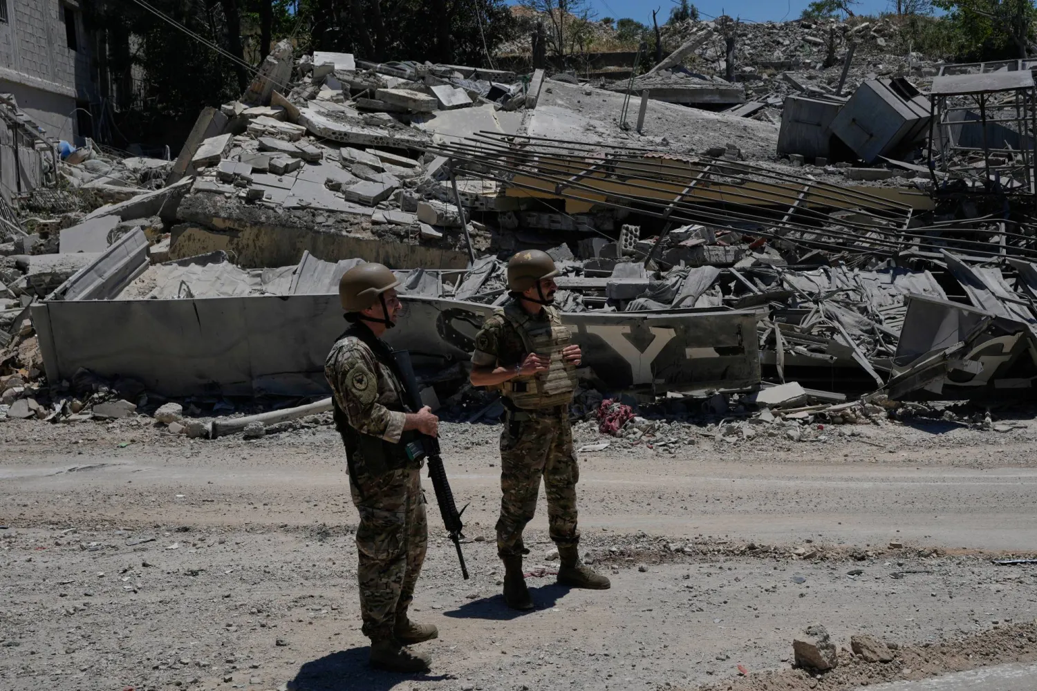 Lebanese army soldiers stand in front of a house that was destroyed in the recent clashes between Hezbollah fighters and Israeli troops in Dibbine village, southeast Lebanon, Friday, June 5, 2026, a day after Israeli forces withdrew. (AP Photo/Hussein Malla)