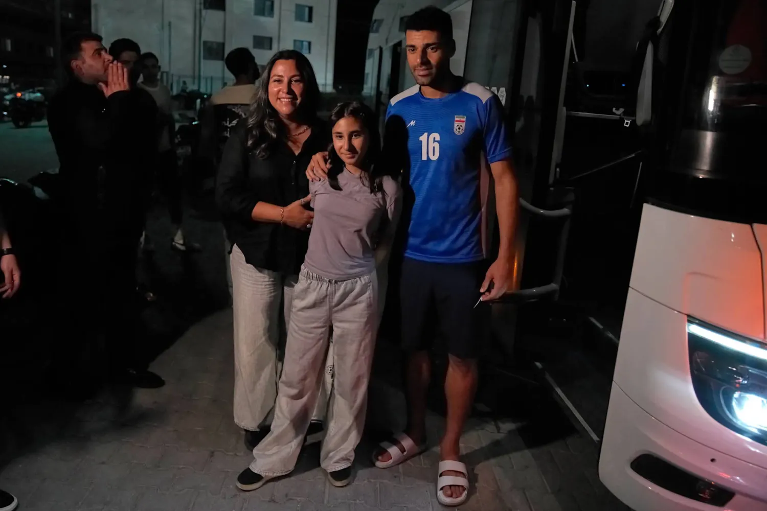 Iran's Mehdi Torabi, right, poses for a photo with fans after a friendly soccer match between Iran and Mali, in Antalya, southern Türkiye, Thursday, June 4, 2026, ahead of the World Cup soccer tournament. (AP Photo/Khalil Hamra)