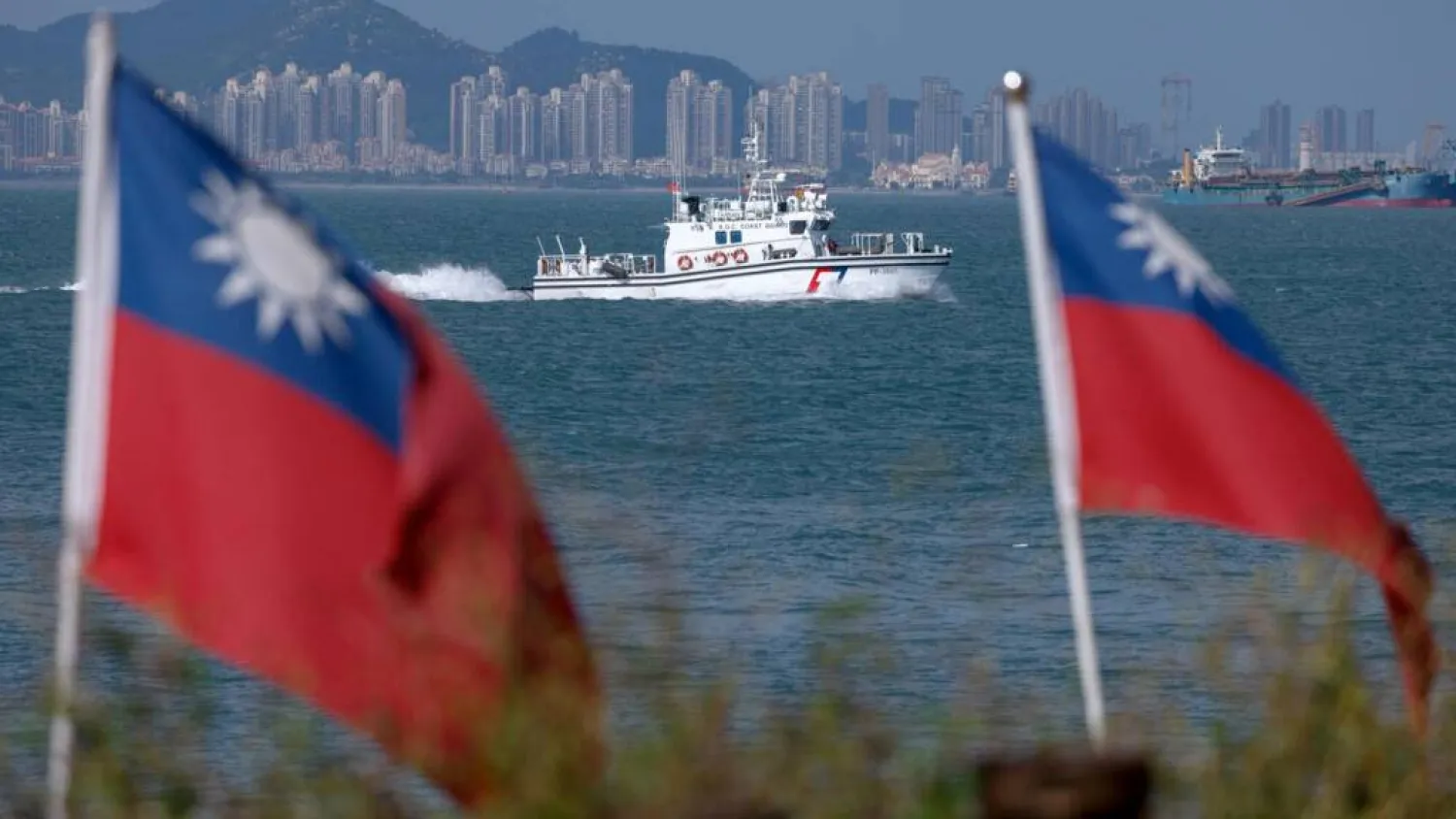 A Taiwan Coast Guard ship patrols near Dadan Island, with the Chinese city of Xiamen visible in the background on October 18, 2025.  Ann Wang, Reuters
