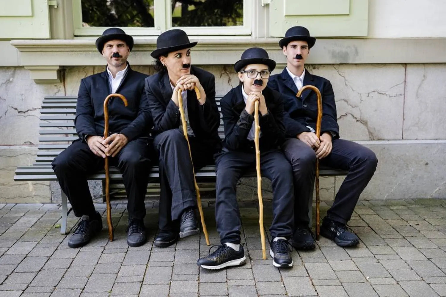 Some of the 429 people dressed as "The Tramp" pose for a photo during the 10th anniversary of Chaplin's World, the museum dedicated to the life of Charlie Chaplin, in Corsier-sur-Vevey, Switzerland, 07 June 2026. (EPA)
