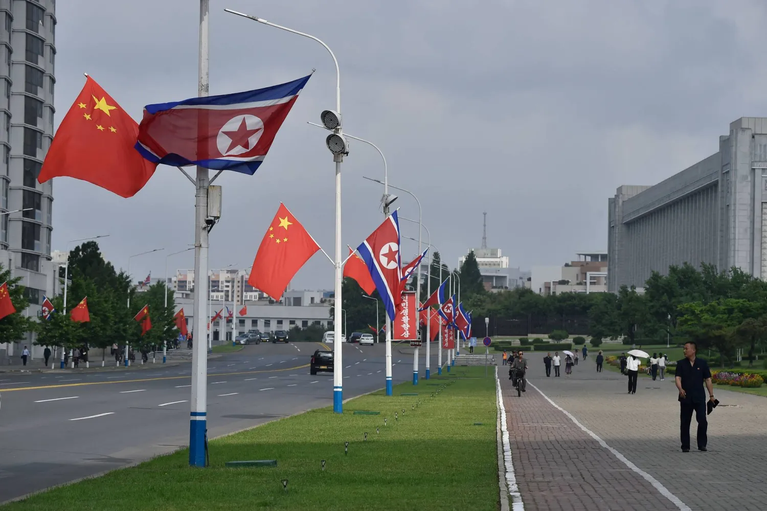 The national flags of North Korea and China are displayed on a street in Pyongyang on June 8, 2026. (AFP)