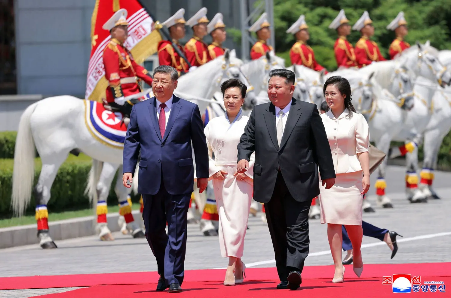 This picture taken on June 8, 2026 and released by North Korea's official Korean Central News Agency (KCNA) on June 9, 2026 shows North Korean leader Kim Jong Un (2nd R) with his wife Ri Sol Ju (R) and China's President Xi Jinping (L)} and his wife Peng Liyuan (2nd L) attending a welcoming ceremony at Kim Il Sung Square in Pyongyang. (KCNA via KNS / AFP)