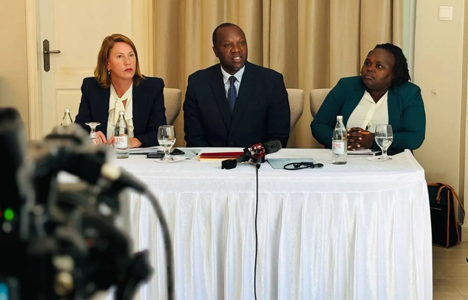  Lawyers Antonio Mulvay, left, and Willis Otieno, center, who are part of the legal team filing a law suit against Sudan's Rapid Support Forces (RSF) on behalf of Sudanese torture victims, speak to the media in Nairobi, Tuesday June 9, 2026. (AP) 
