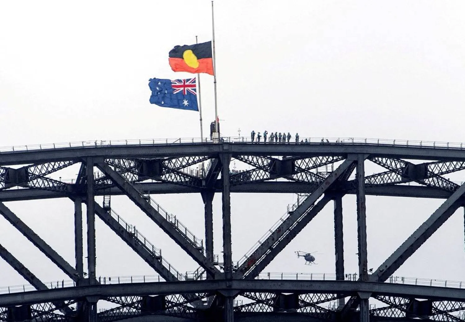 Australia's national flag and the Aboriginal flag flutter at half mast on the Sydney Harbor Bridge during Australia's National Day of Mourning for the victims of the December 14, 2025, mass shooting at a Jewish Hanukkah celebration at Bondi Beach, in Sydney, Australia, January 22, 2026. (Reuters)