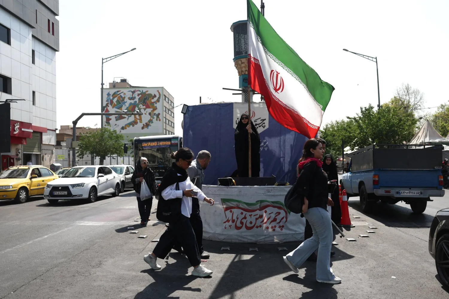 A woman holds an Iranian flag on a street in Tehran, Iran, June 10, 2026. Majid Asgaripour/WANA (West Asia News Agency) via REUTERS