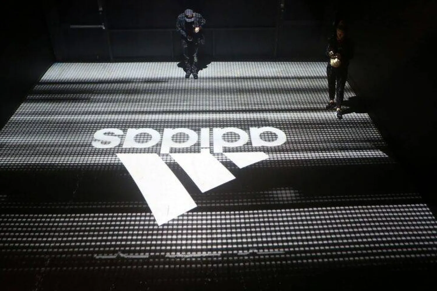 FILE PHOTO: An Adidas logo is seen at the new Futurecraft shoe unveiling event in New York City, New York, US April 6, 2017. REUTERS/Joe Penney/File Photo 