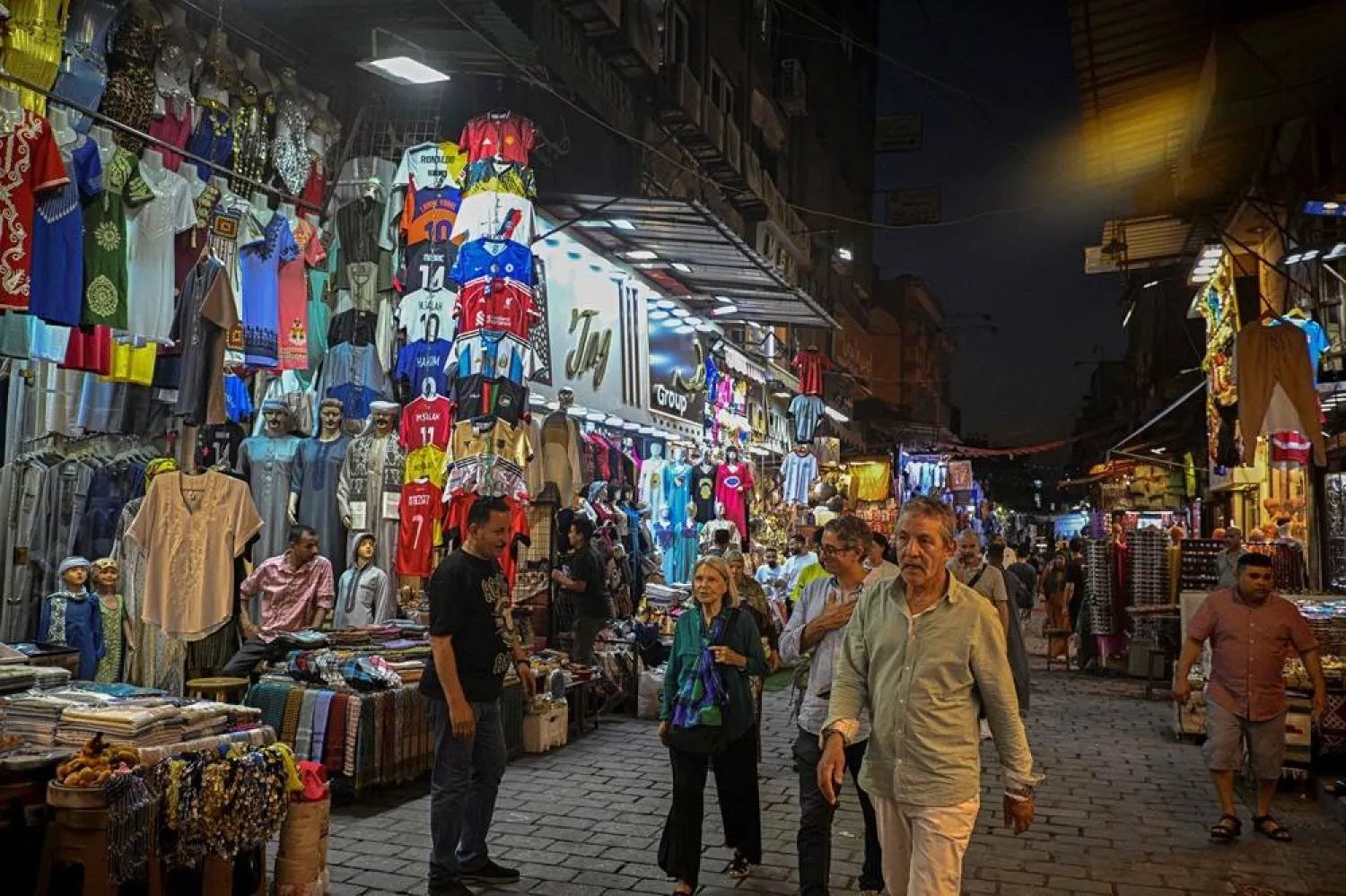 People walk past a shop selling football jerseys in Khan el-Khalily Bazar in Cairo on June 9, 2026. (AFP)