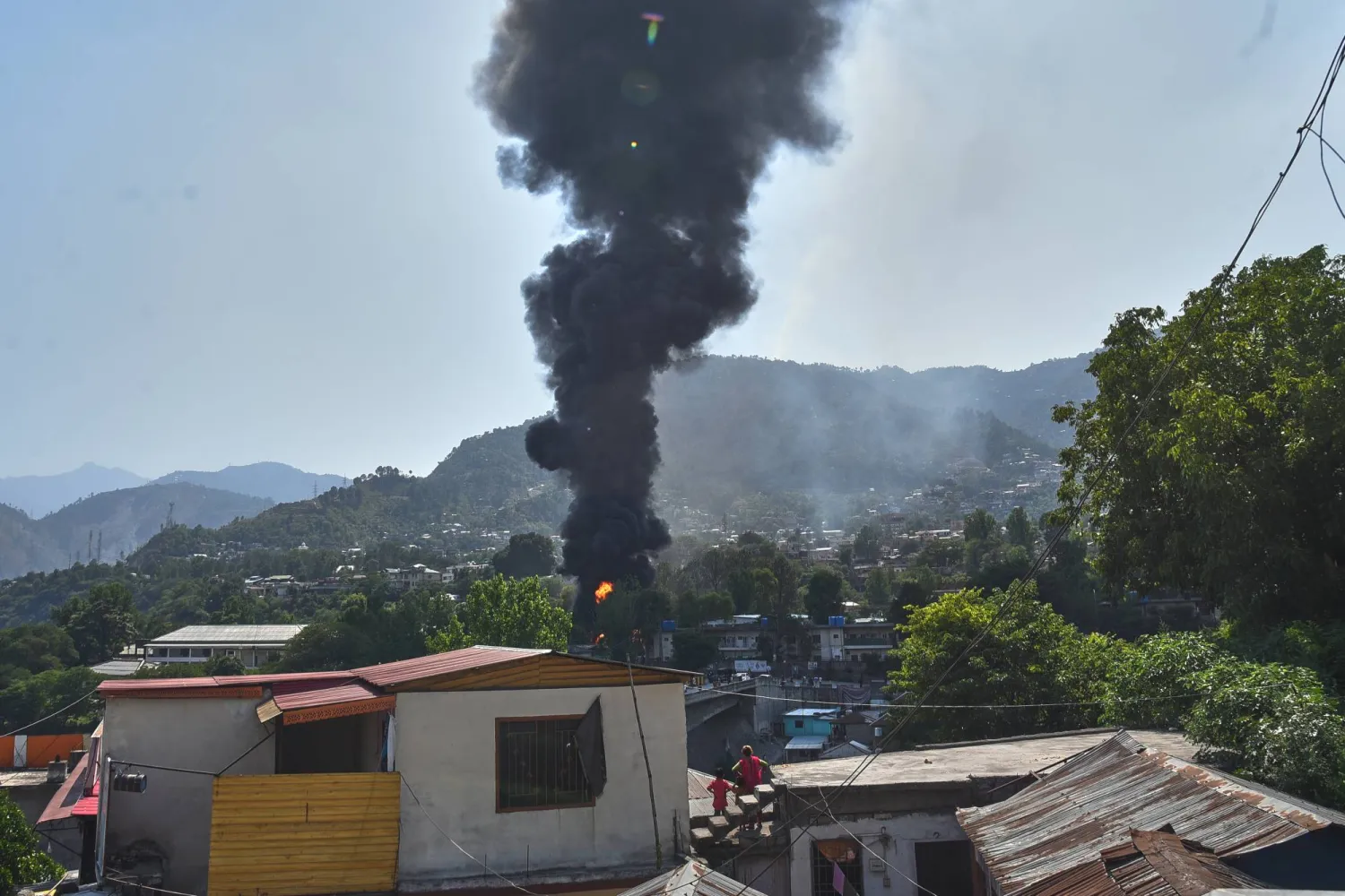 Smoke billows after an army MI-17 helicopter crashed due to a technical fault, in Muzaffarabad, capital of Pakistan-administered Kashmir, Wednesday, June 10, 2026. (AP Photo/M.D. Mughal)