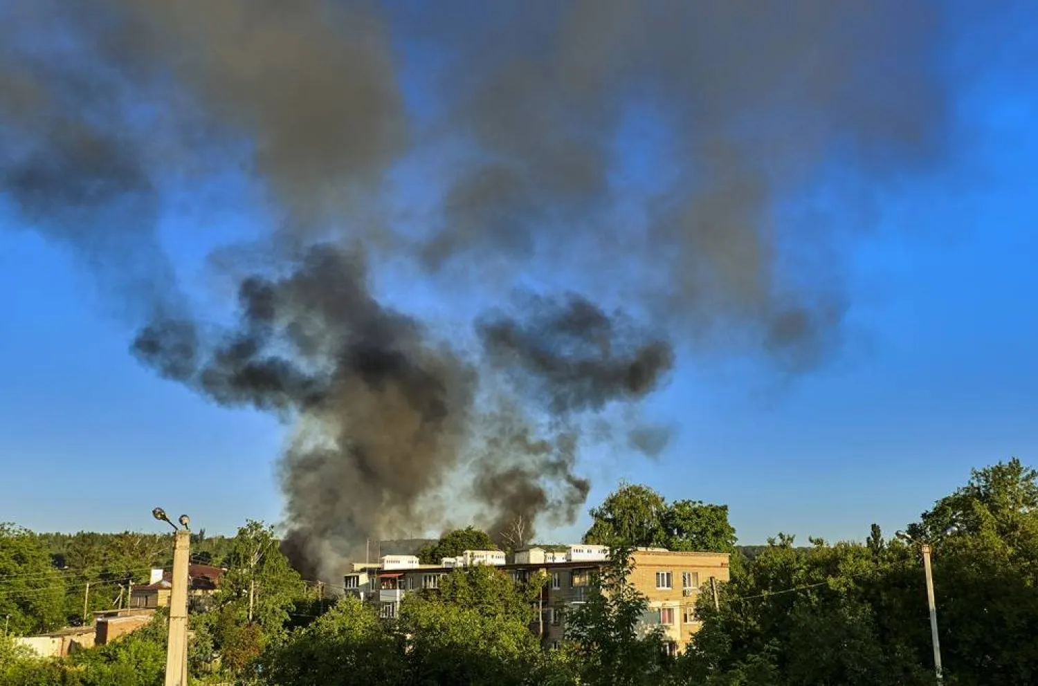Smoke rises above the city after a Russian strike on a residential area in Kharkiv, Ukraine, 10 June 2026, amid the ongoing Russian invasion. (EPA) 