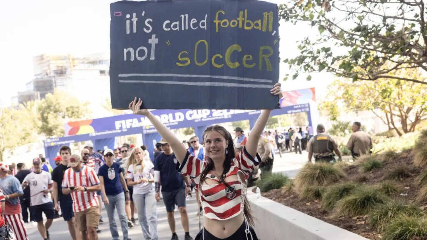A USA fan holds a sign as she arrives at Los Angeles Stadium (SoFi Stadium) to attend the 2026 FIFA World Cup match between USA and Paraguay in Inglewood, California, on June 12, 2026. ETIENNE LAURENT / AFP
