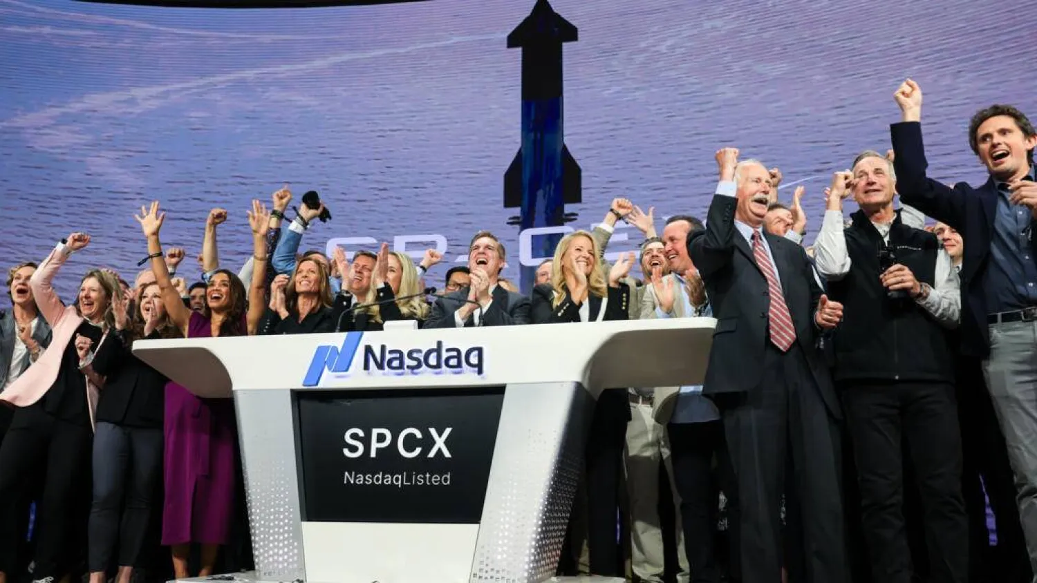 SpaceX employees celebrate the company's Wall Street debut, the largest initial public offering in US history. TIMOTHY A. CLARY / AFP
