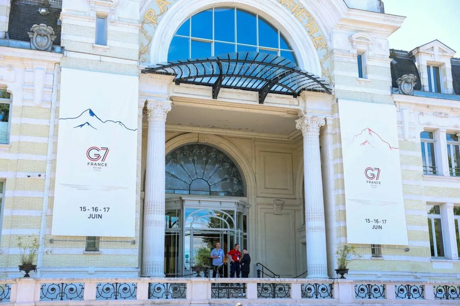 People stand outside the Palais Lumiere ahead of the G7 summit in Evian-les-Bains, France, June 12, 2026. (Reuters)