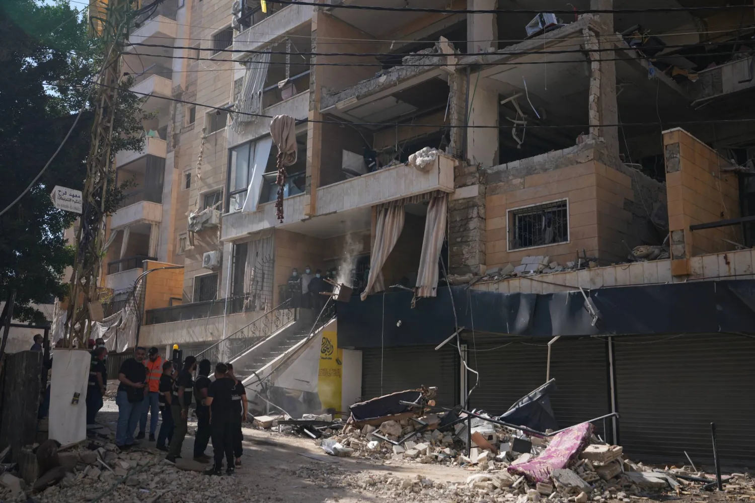 Lebanese security officers gather at the site where an Israeli airstrike hit a building in Dahiyeh, Beirut's southern suburb, Lebanon, Sunday, June 7, 2026. (AP Photo/Hassan Ammar)