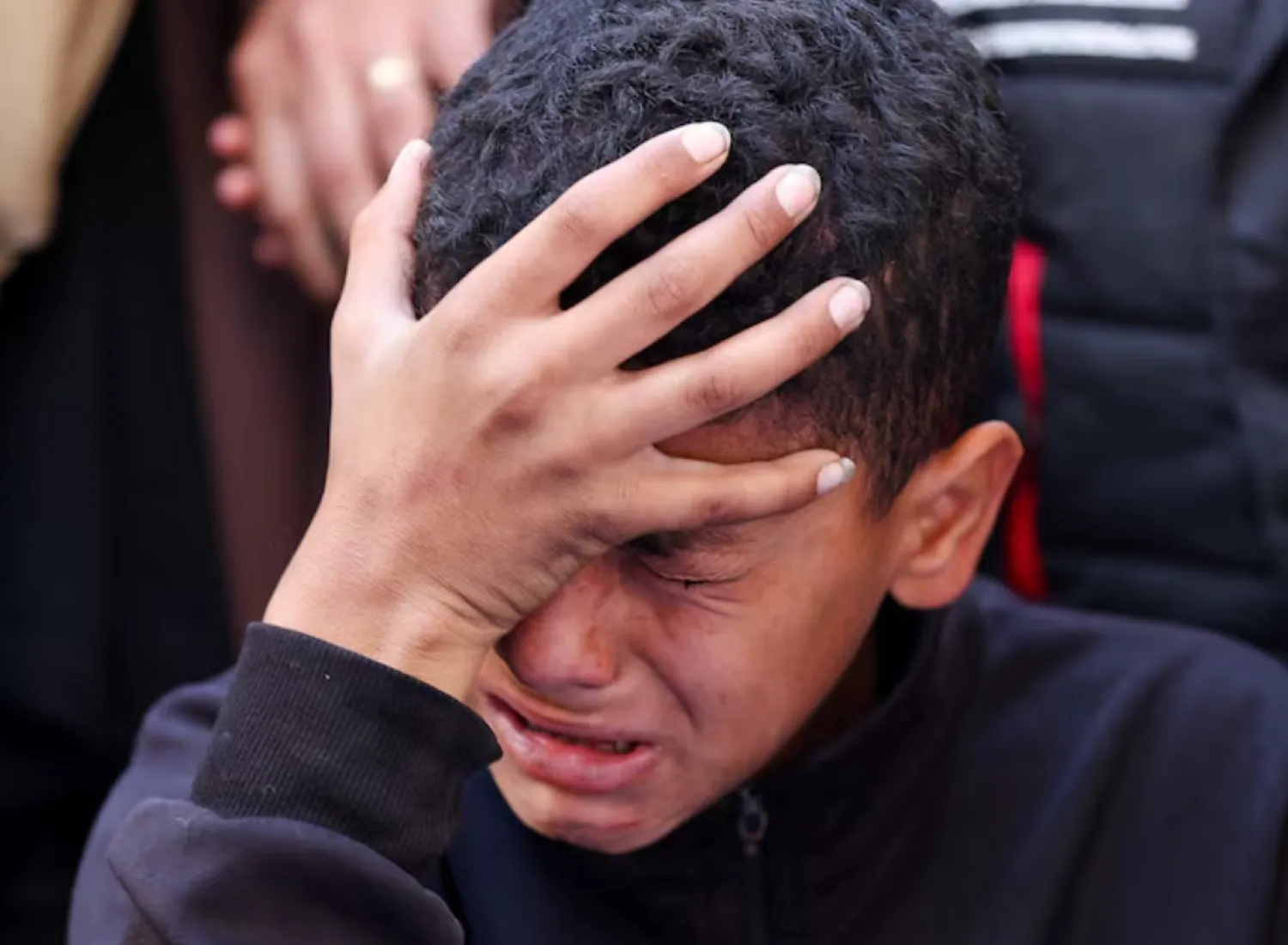A boy reacts during the funeral of Palestinians who, according to medics, were killed in an Israeli strike, in Gaza City, March 30, 2026. REUTERS/Dawoud Abu Alkas 