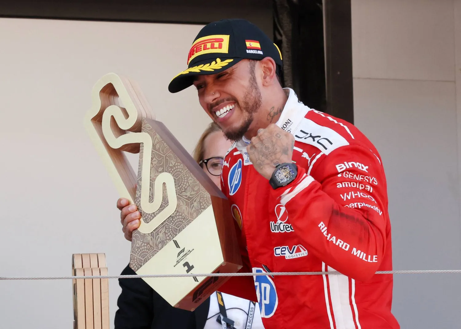 Formula One F1 - Barcelona-Catalunya Grand Prix - Circuit de Barcelona-Catalunya, Barcelona, Spain - June 14, 2026 Ferrari's Lewis Hamilton celebrates on the podium with a trophy after winning the Barcelona-Catalunya Grand Prix REUTERS/Bruna Casas