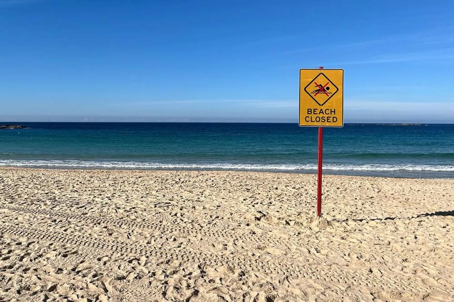 A beach closed sign is displayed at Coogee Beach in Sydney on June 13, 2026. (AFP)