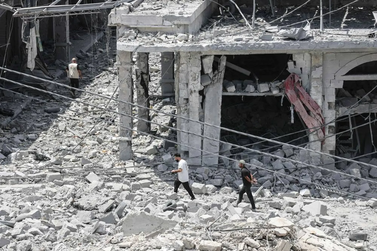  People make their way through the rubble of a destroyed building as residents displaced by fighting return to Nabatieh in southern Lebanon on June 15, 2026. (AFP)