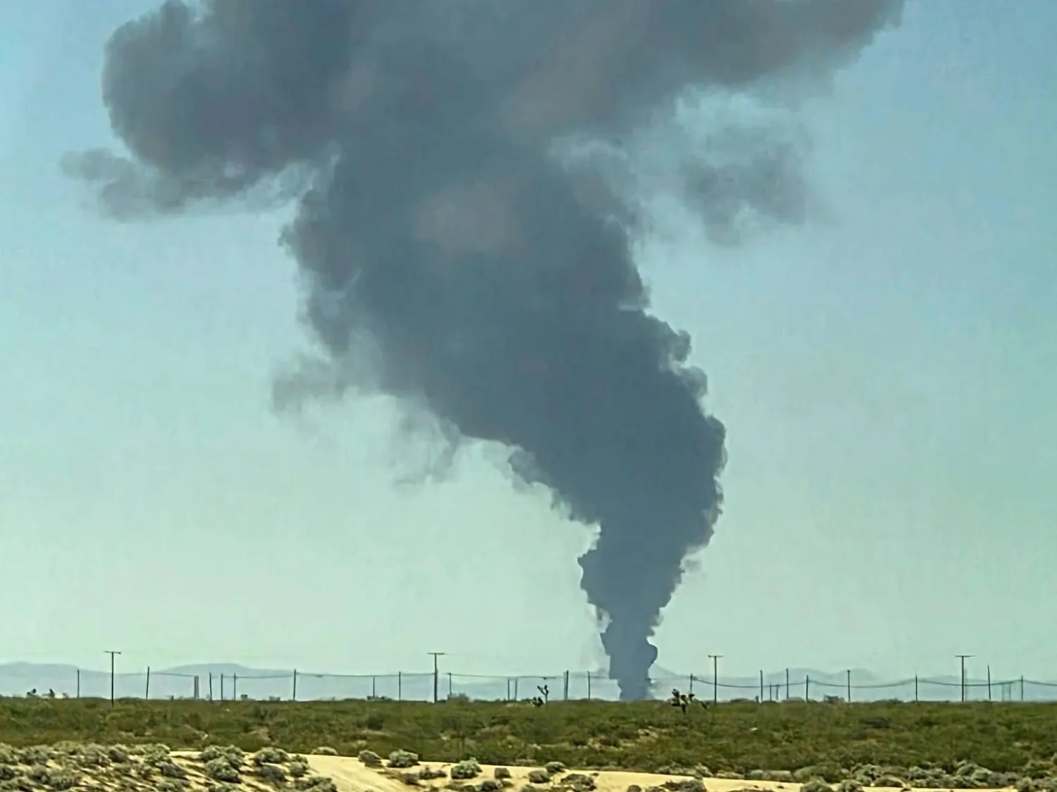 Smoke plumes rise from a B-52 bomber that crashed shortly after takeoff at a US Air Force base in Southern California, Monday, June 15, 2026. (Debbie Reyes Katz via AP Photo)