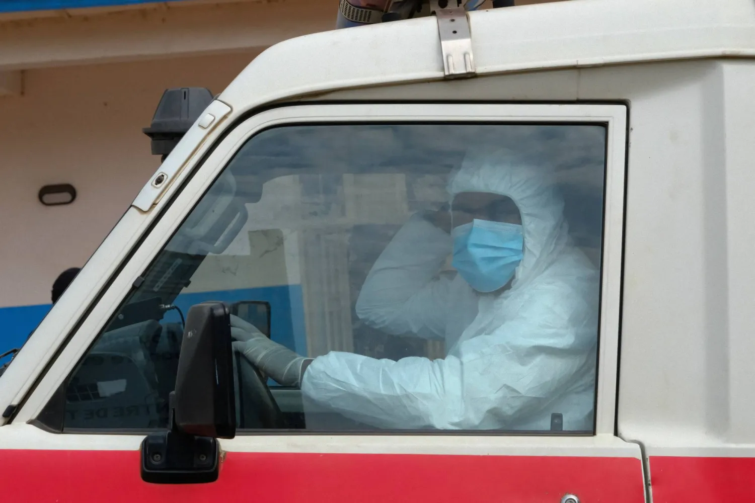 A doctor wearing personal protective equipment (PPE) sits in an ambulance at the Ebola Virus Disease Treatment Center at the Bunia General Reference Hospital, one month after cases were confirmed in Bunia, eastern Democratic Republic of Congo, June 15, 2026. REUTERS/Gradel Muyisa Mumbere