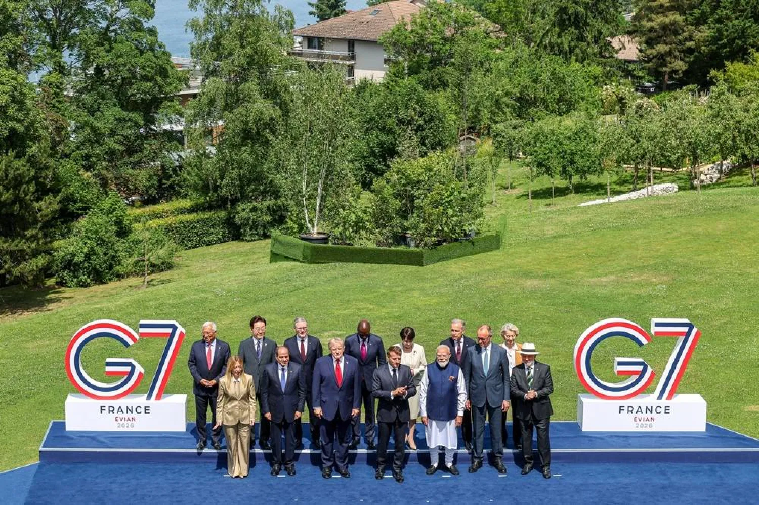 US President Donald Trump, French President Emmanuel Macron, Canadian Prime Minister Mark Carney, Italian Prime Minister Giorgia Meloni, Japanese Prime Minister Sanae Takaichi, European Commission President Ursula von der Leyen, European Council President Antonio Costa, German Chancellor Friedrich Merz, Egyptian President Abdel Fattah al-Sisi, South Korea's President Lee Jae Myung, India's Prime Minister Narendra Modi, Brazilian President Luiz Inacio Lula da Silva, Kenya's President William Ruto and British Prime Minister Keir Starmer pose during a family photo at the G7 summit in Evian, France, on Tuesday June 16, 2026. (Pool via Reuters) 