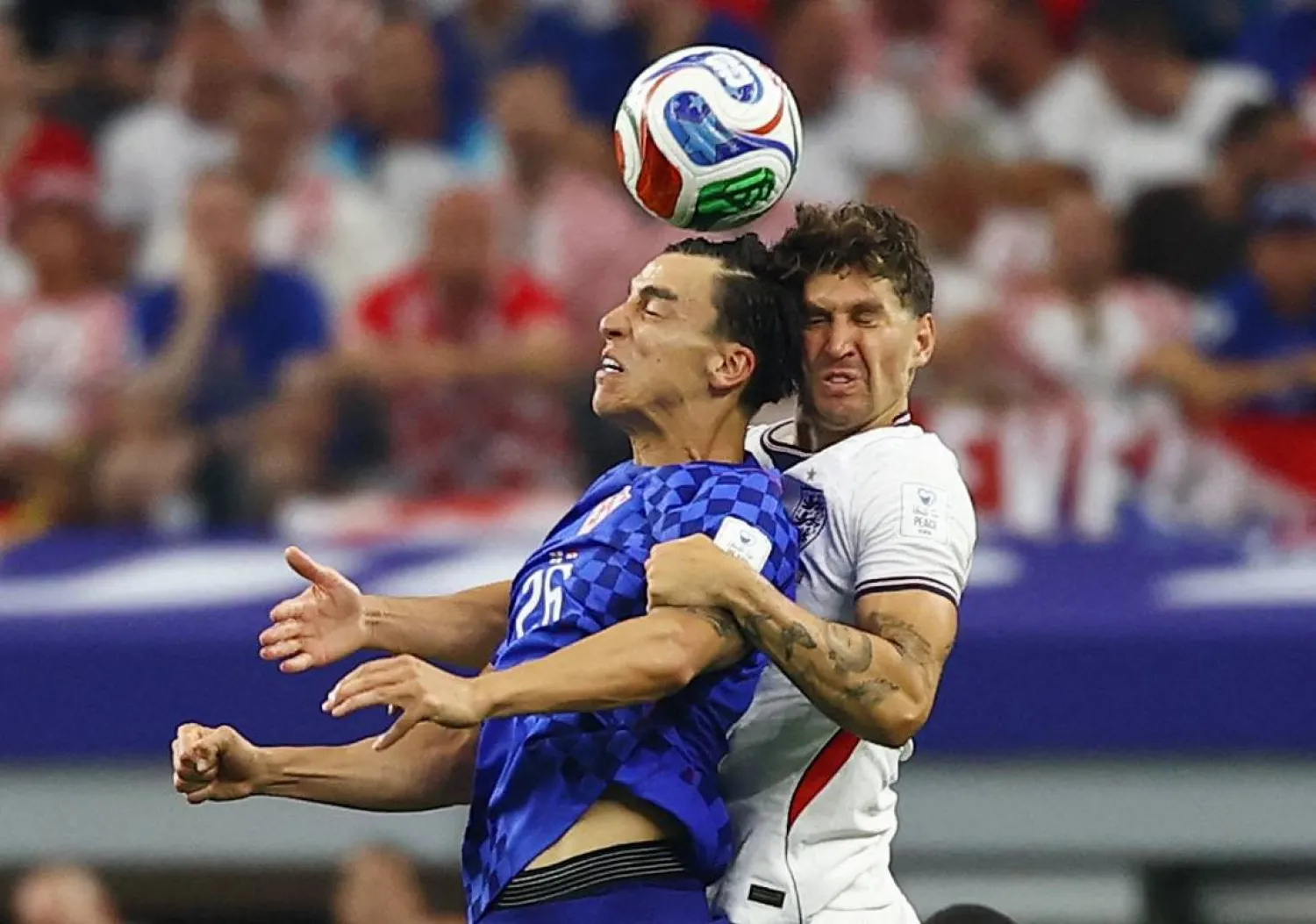 لاعب المنتخب الكرواتي بيتر موسا في صراع على الكرة مع مدافع منتخب إنجلترا جون ستونز (رويترز)