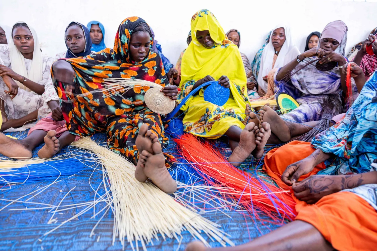 Chadian women weave plastic threads in Tongori camp for Chadian returnees, on June 9, 2026. (Photo by Joris Bolomey / AFP)