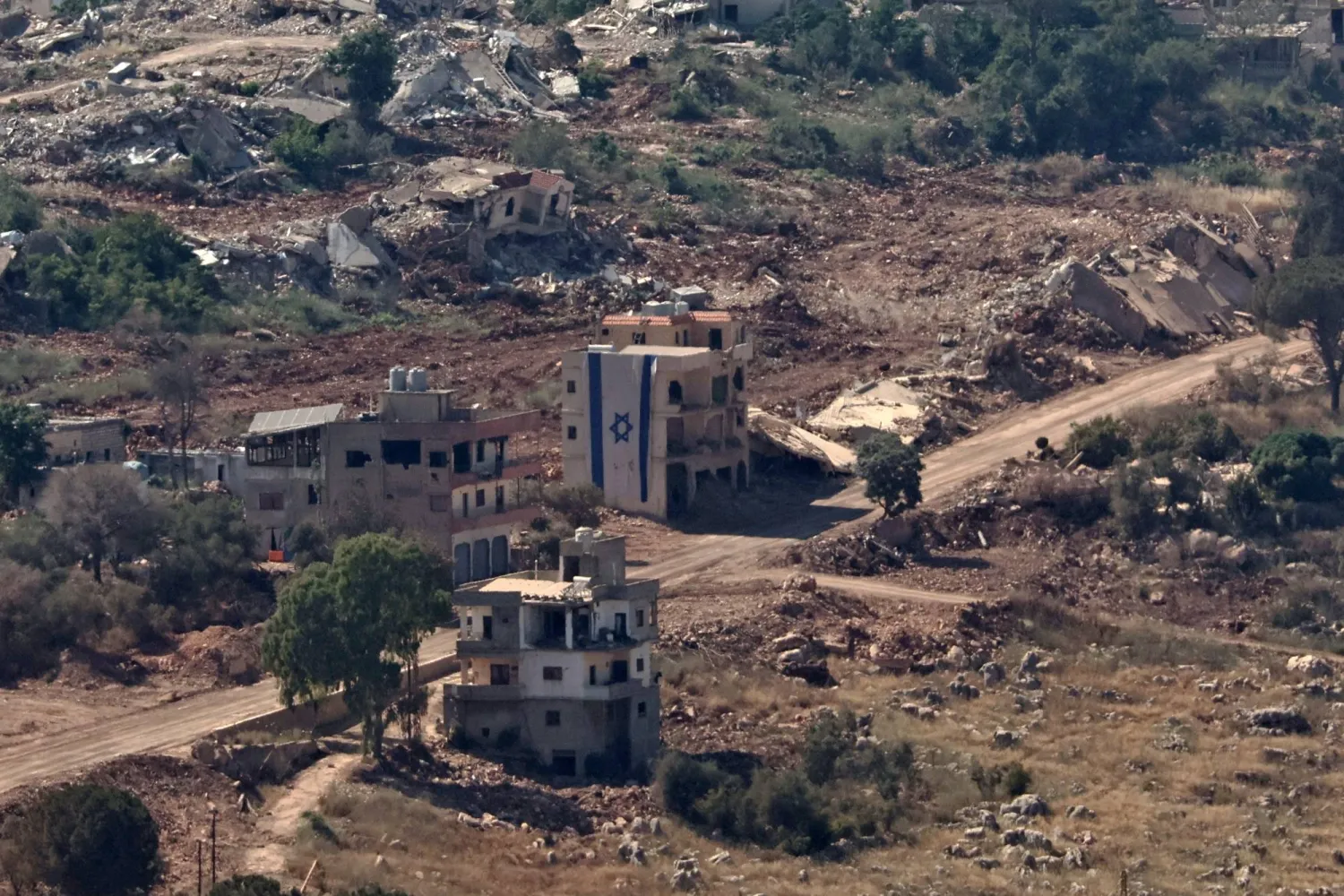 An Israeli flag tagged on a building in the southern Lebanese village of Taybeh, as seen from the Israeli side of the border in the Upper Galilee, northern Israel, 17 June 2026. EPA/ATEF SAFADI