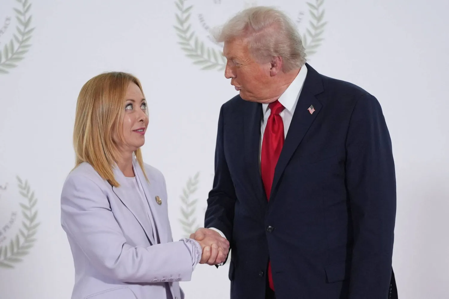 (FILES) US President Donald Trump greets Italy's Prime Minister Giorgia Meloni during a summit on Gaza in Sharm el-Sheikh on October 13, 2025. (Photo by Evan Vucci / POOL / AFP)