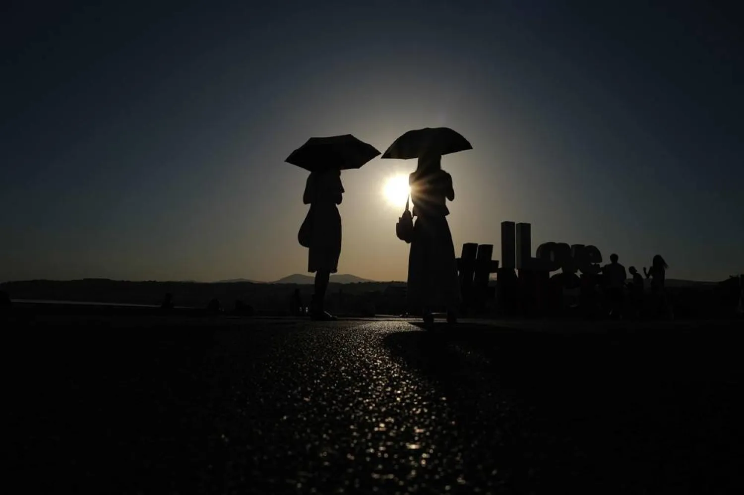 Two women walk in front of the sea at the beginning of the "Promenade des Anglais" on the French riviera city of Nice, on June 20, 2026. (AFP)