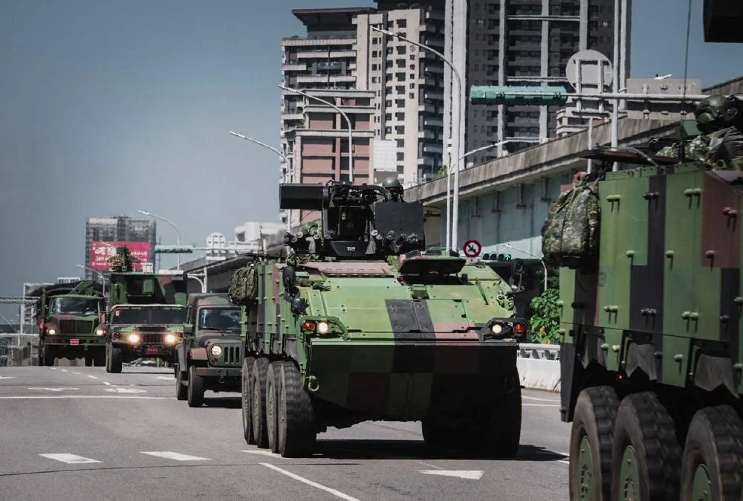 This picture taken and released by Taiwan's Central News Agency (CNA) on June 22, 2026 shows a row of armored military vehicles driving along the highway in Taoyuan, Taiwan. (AFP photo / CNA Photo)