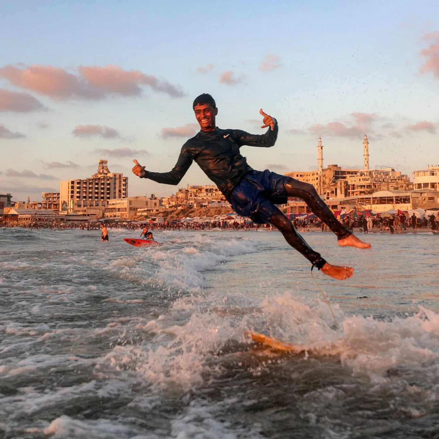 Surfers still ride the waves off Gaza City, despite the devastation wreaked on the Palestinian territory during the recent conflict. Omar AL-QATTAA / AFP
