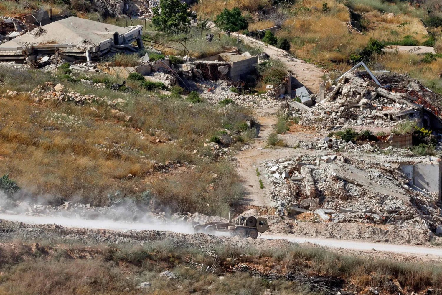 This picture taken from a position in northern Israel, near the border with Lebanon shows an Israeli military vehicle driving along a road in southern Lebanon on June 22, 2026. (AFP)