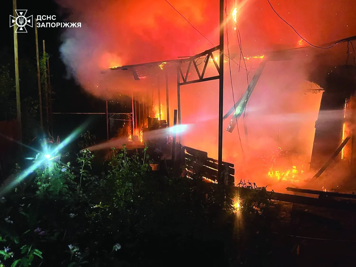In this photo provided by the Ukrainian Emergency Service, emergency services personnel work to extinguish a fire following a Russian air attack in in Zaporizhzhia region, Ukraine, Monday, June 22, 2026. (Ukrainian Emergency Service via AP)