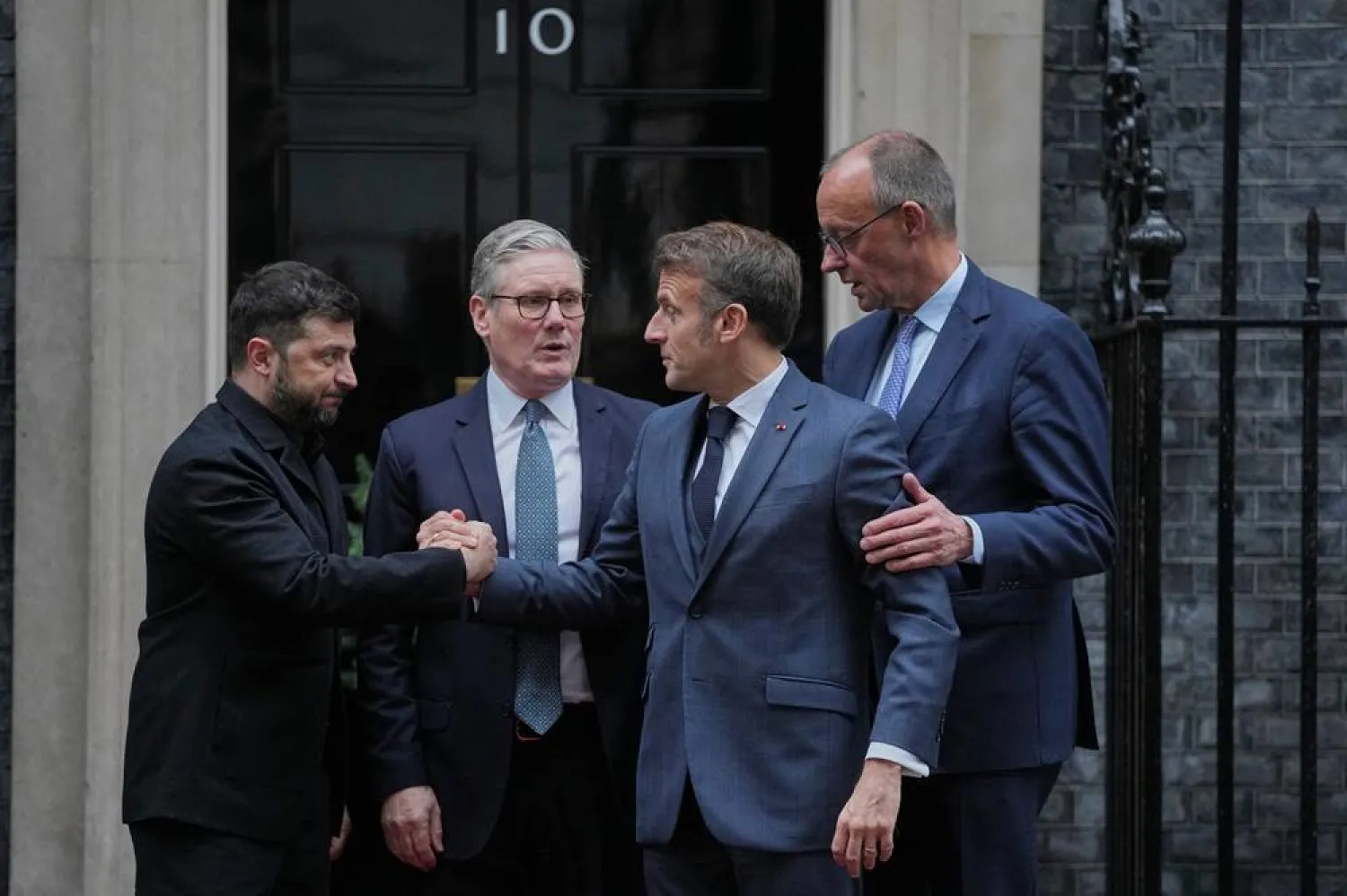 Ukraine's President Volodymyr Zelenskiy, left, with, from second left, Britain's Prime Minister Keir Starmer, France's President Emmanuel Macron, and Germany's Chancellor Friedrich Merz pose on the doorstep of 10 Downing Street, London, Dec. 8, 2025, following a meeting of the leaders inside. (AP) 