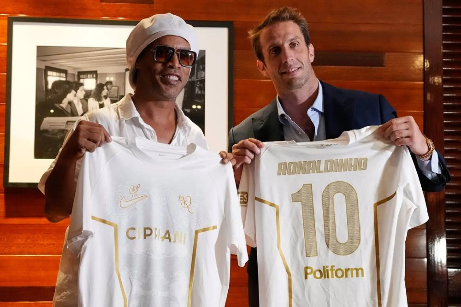 Brazilian football legend Ronaldinho, left, holds up jerseys along with Ignazio Cipriani, president of Ravenna FC, at a media event celebrating Ronaldinho's recent signing with the Italian club, at Cipriani Downtown Miami restaurant, Tuesday, June 23, 2026, in Miami. (AP) 