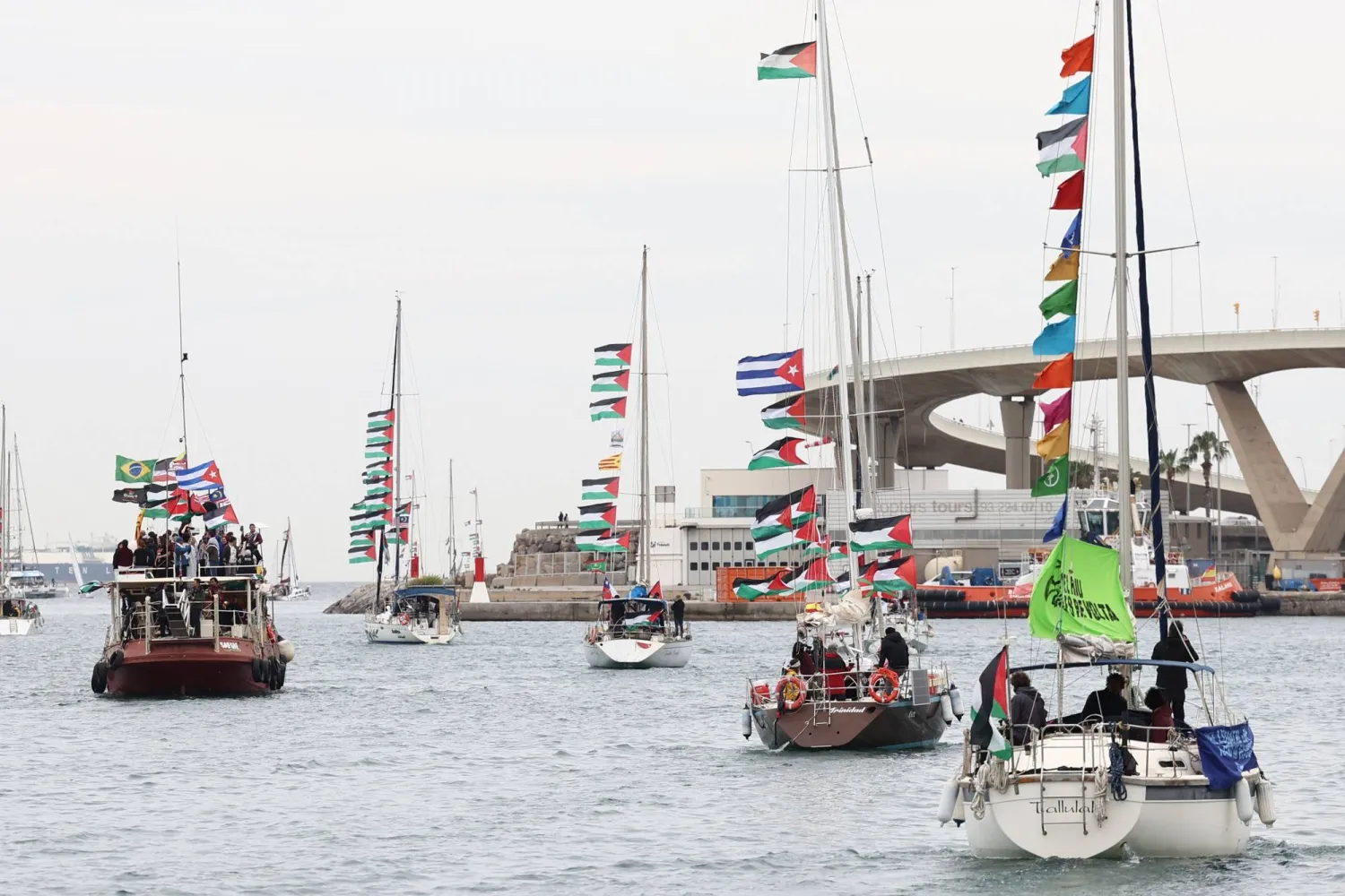 Boats of a new humanitarian flotilla bound for the Gaza Strip make a symbolic leave from Barcelona's Port Vell on April 12, 2026 as the departure of the flotilla has been postponed due to bad weather. (AFP)