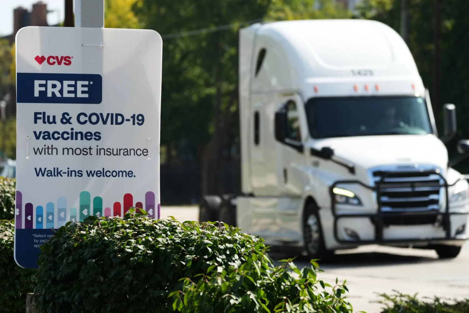 FILE - A sign for flu & COVID-19 vaccines is displayed outside a CVS store in Buffalo Grove, Ill., Sept. 23, 2025. (AP Photo/Nam Y. Huh, file)