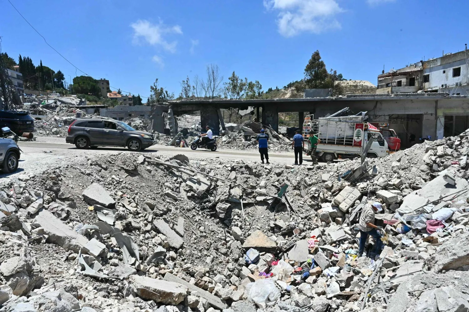 Residents arrive to inspect what is left of their homes and businesses, destroyed in Israeli military strikes, in the southern Lebanese village of Srifa on June 24, 2026. (Photo by FADEL itani / AFP) / 
