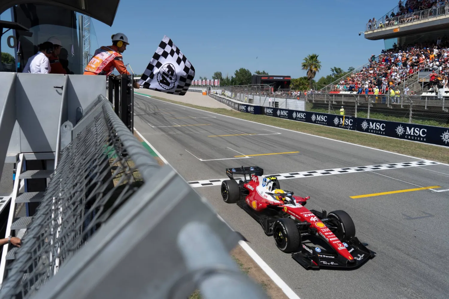 Ferrari driver Lewis Hamilton of Britain crosses the finish line to win the Spain F1 Grand Prix race at the Barcelona Catalunya racetrack in Montmelo, near Barcelona, Spain, Sunday, June 14, 2026. (Manaure Quintero/Pool Photo via AP)