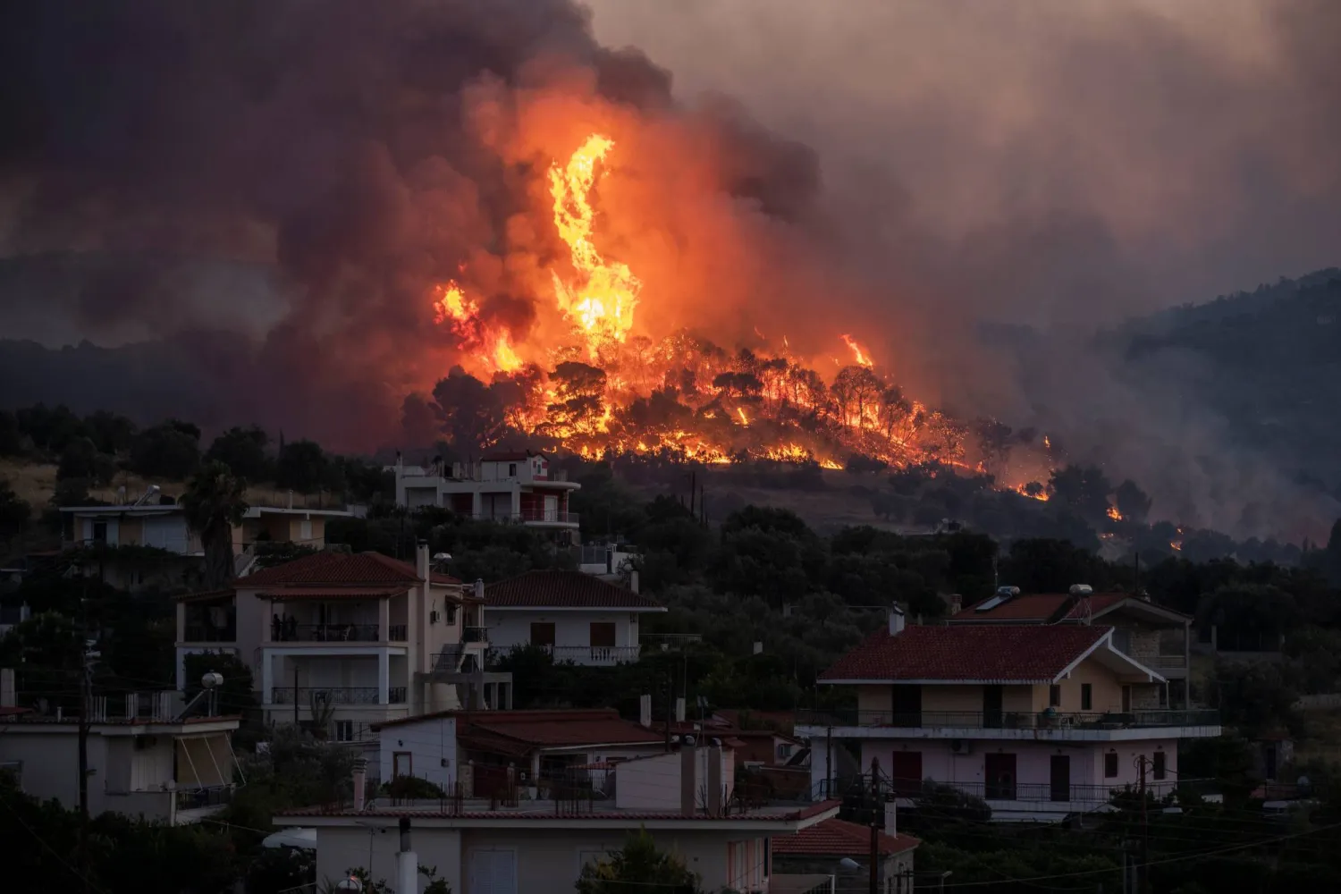 FILE - Fire burns near the village of Galataki as authorities evacuate the place near Corinth, Greece, July 22, 2020.(AP Photo/Petros Giannakouris, File)