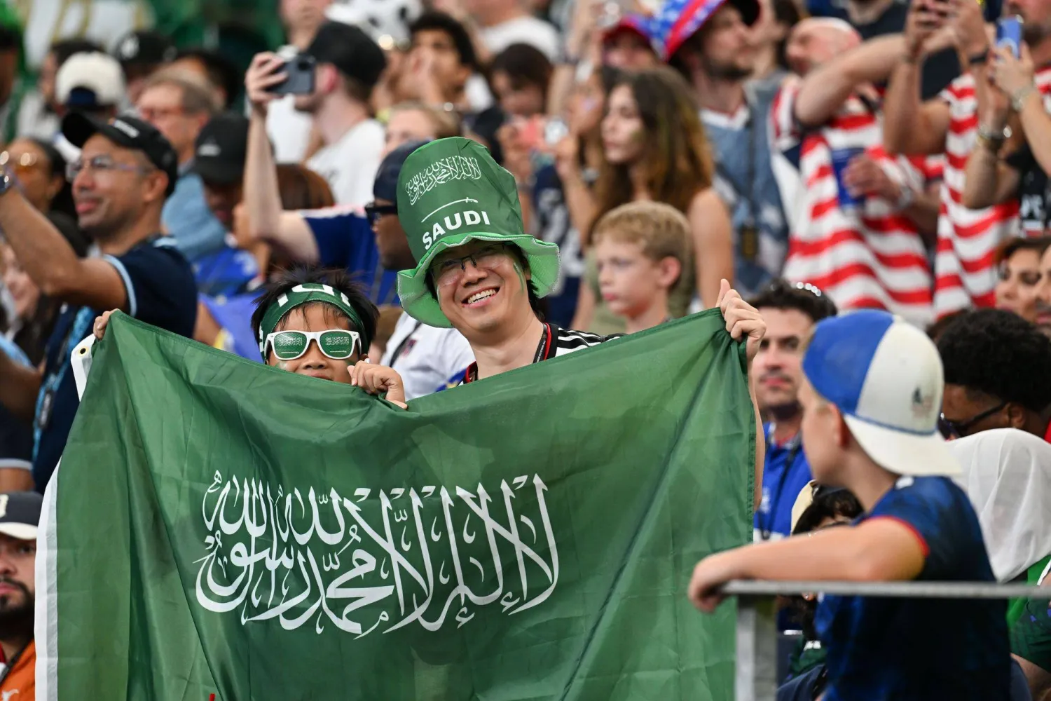 جماهير تتفاعل في المدرجات بالعلم السعودي (د.ب.أ) 