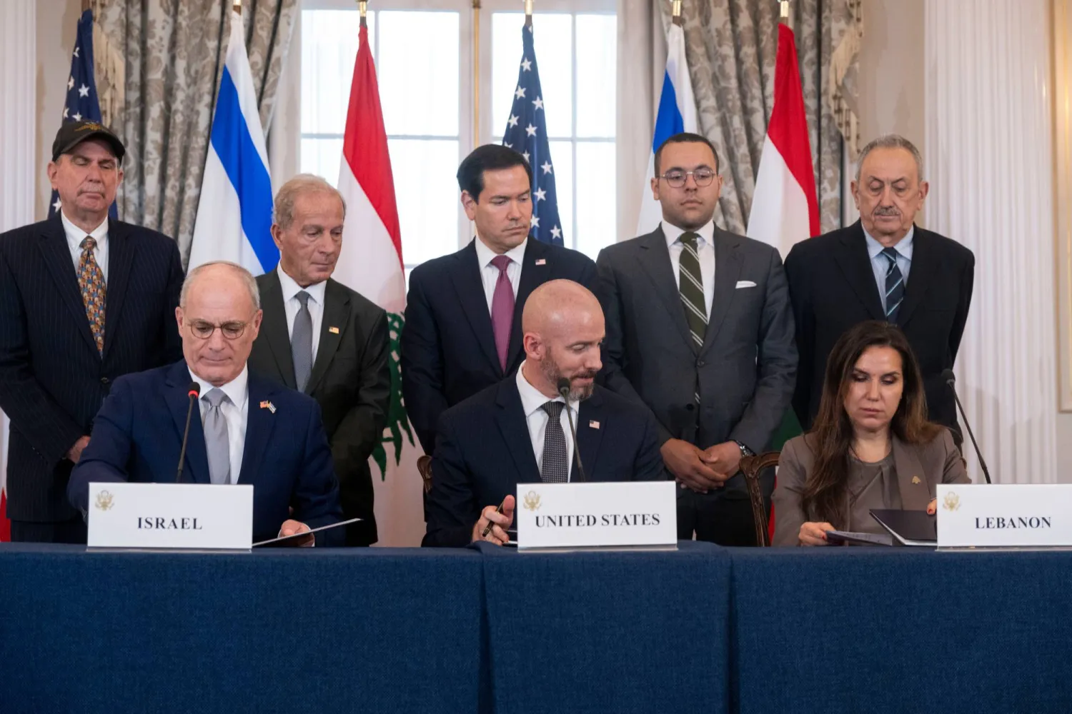 Secretary of State Marco Rubio and others watch, as seated from left, Israel's Ambassador to the US Yechiel Leiter, counselor Dan Holler, and Lebanon's Ambassador to the US Nada Hamadeh, sign a framework agreement, described as a first step toward peace following months of conflict between Israel and the Lebanese militant group Hezbollah, at the State Department, Friday, June 26, 2026, in Washington. (AP Photo/Kevin Wolf)

