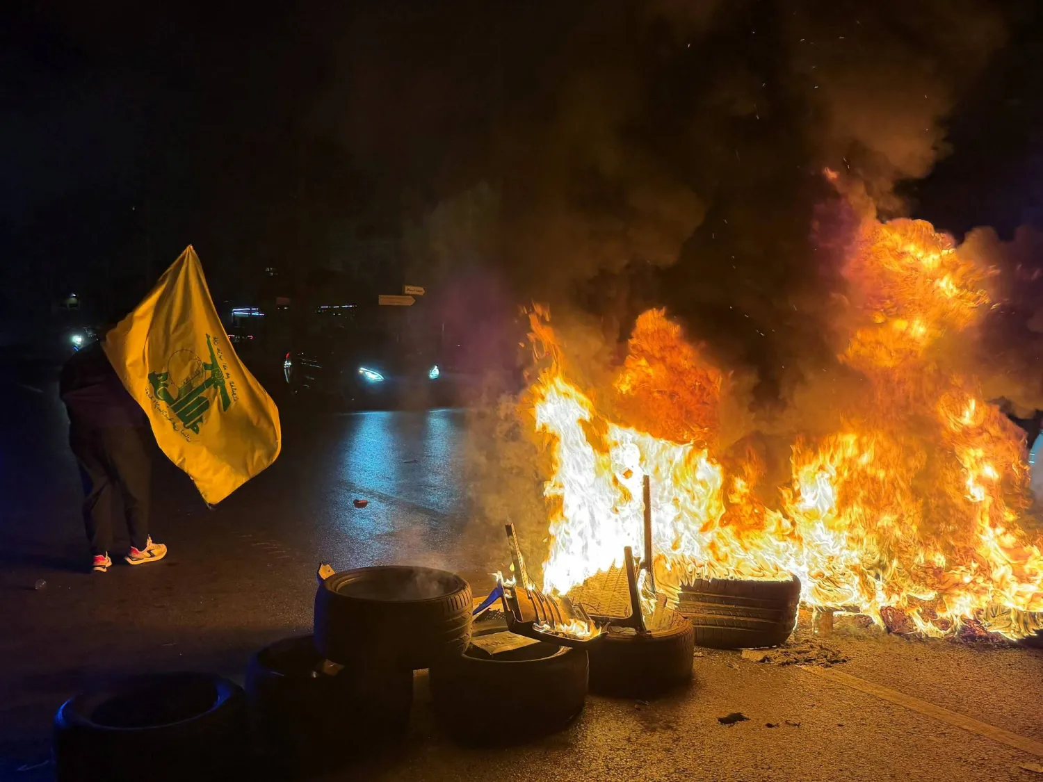 Hezbollah supporters block the old airport road in the southern suburbs of Beirut, with burning tires to protest against the trilateral agreement that was signed between the US, Israel and Lebanon on June 27, 2026. (Photo by Ibrahim AMRO / AFP)