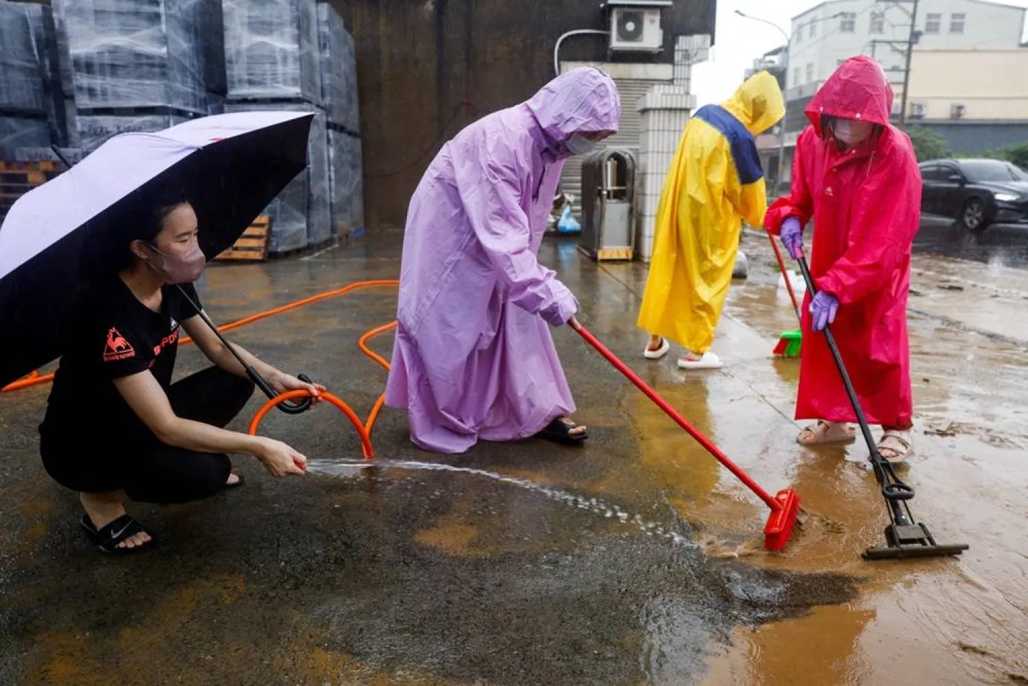  People clean mud and debris from a flooded area after heavy rain brought by Tropical Storm Mekkhala in Hsinchu, Taiwan, June 26, 2026. (Reuters)