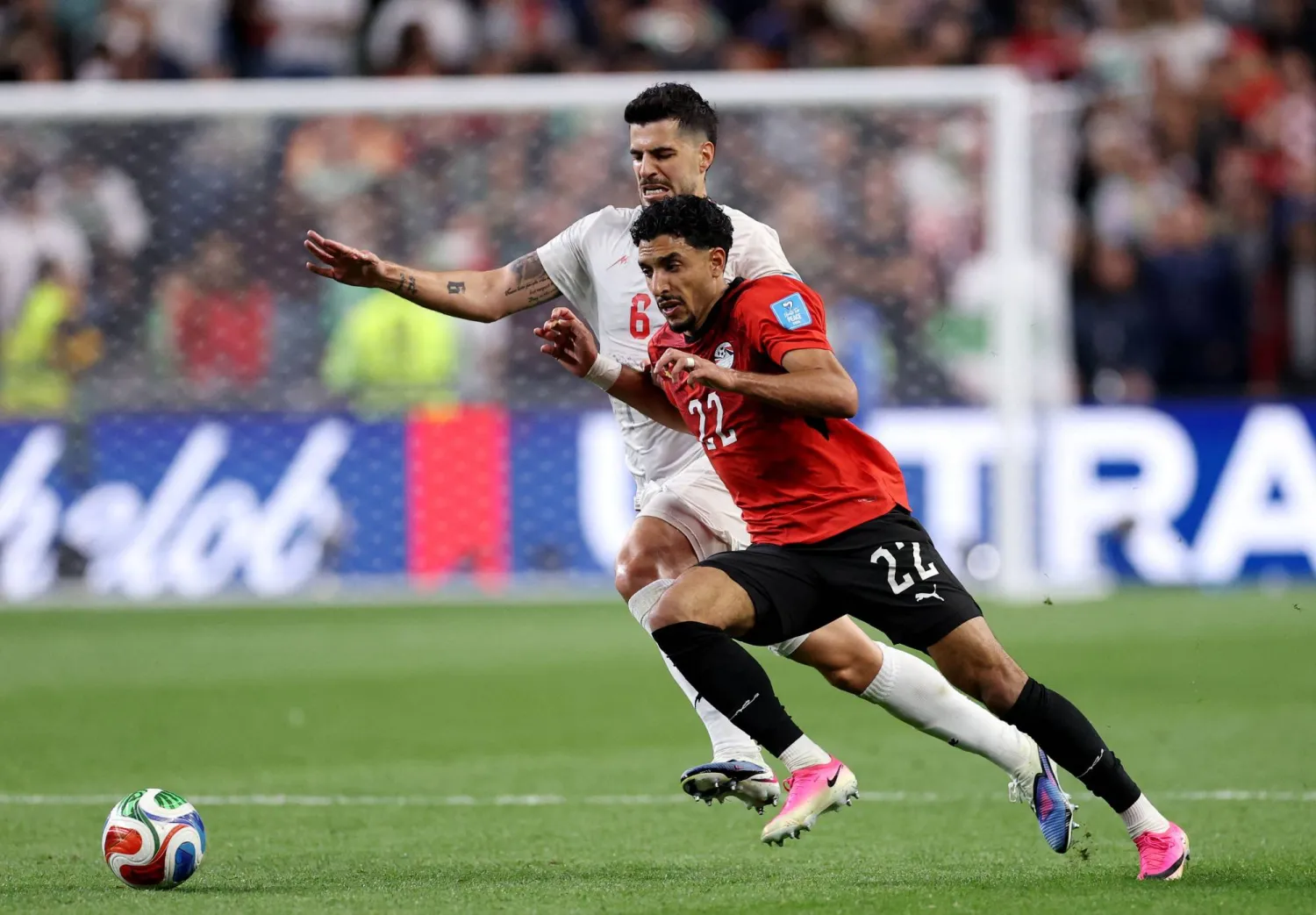 مرموش ينطلق بالكرة وسط ملاحقة من لاعب إيراني (أ.ف.ب)