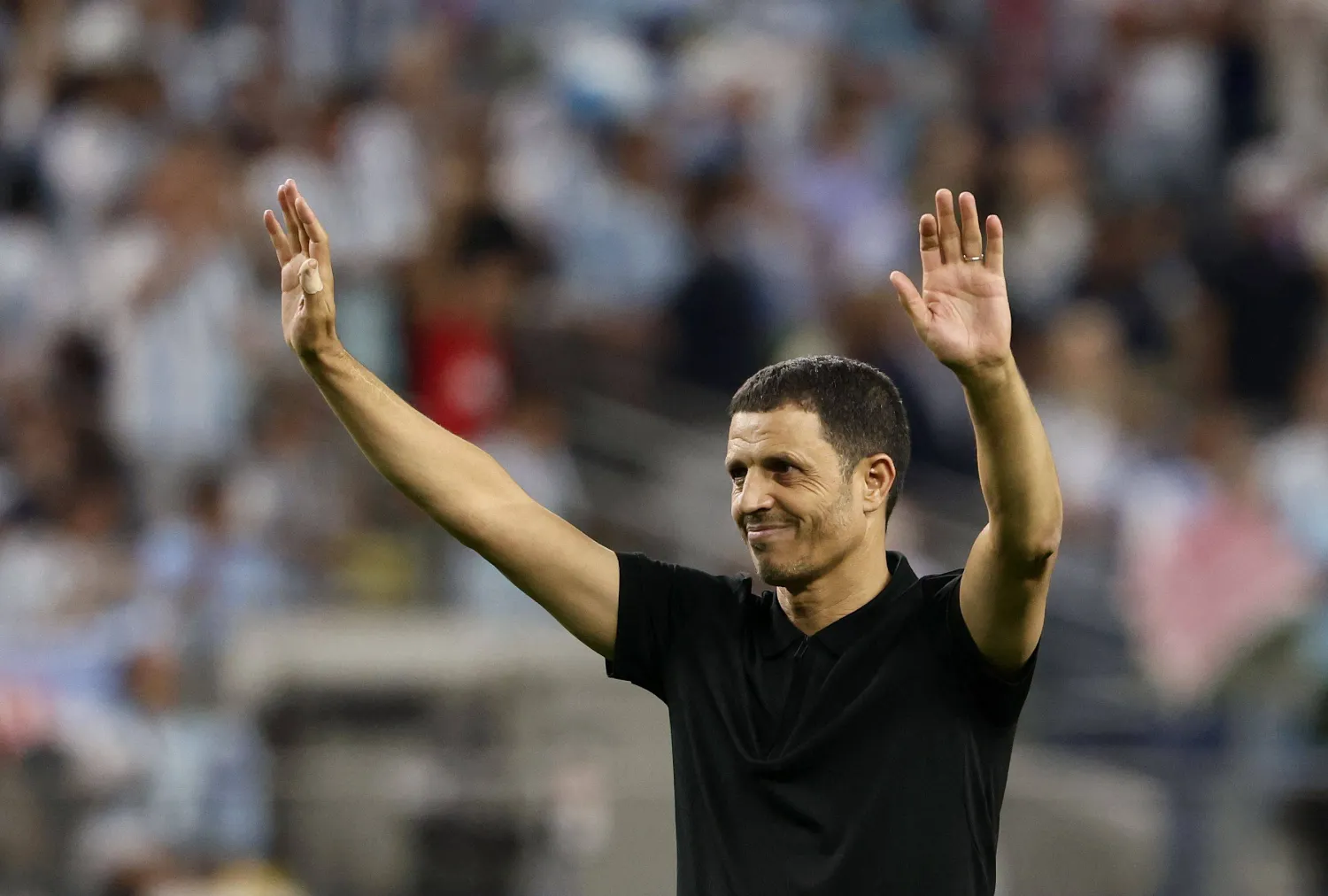 Jordan's Moroccan head coach Jamal Sellami waves to fans after losing the 2026 World Cup Group J football match between Jordan and Argentina at the Dallas Stadium in Arlington on June 27, 2026.  (Photo by Aric Becker / AFP)