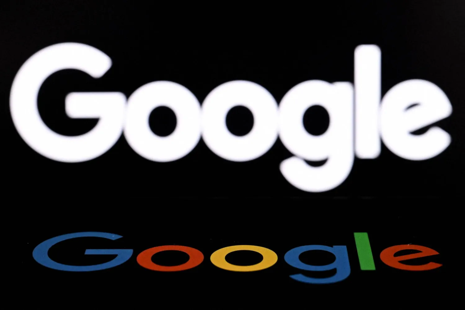 (FILES) A photo taken on May 19, 2026 shows the US multinational technology and Internet-related services company Google displayed on a smartphone (bottom) in front of the Google's logo on a laptop screen in Frankfurt am Main, western Germany. (Photo by Kirill KUDRYAVTSEV / AFP)