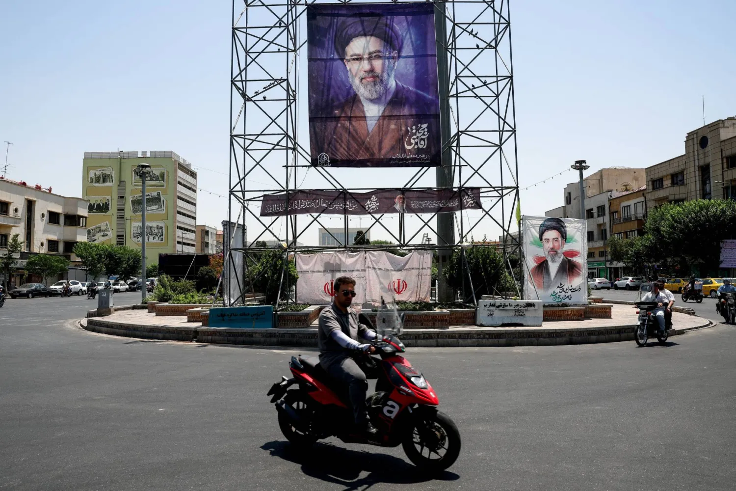 People ride past a banner with a picture of Iran's Supreme Leader, Mojtaba Khamenei, in Tehran, Iran, June 28, 2026. Majid Asgaripour/WANA (West Asia News Agency) via REUTERS 