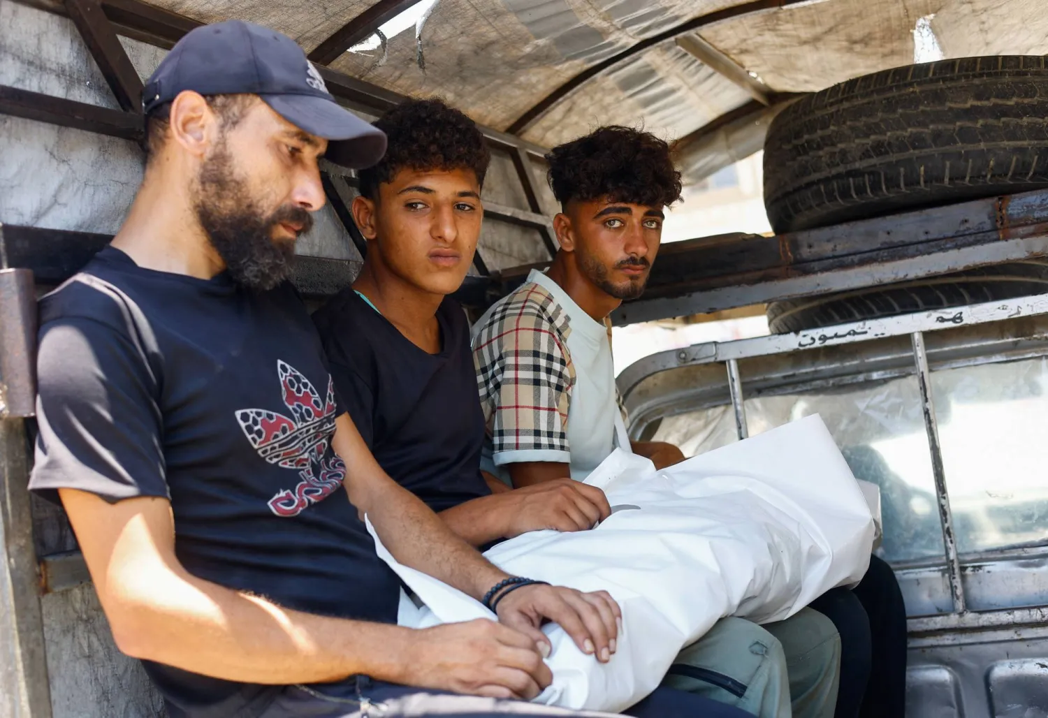 Mourners sit inside a vehicle as they carry the body of Palestinian child Malik Abu Shawish, on the day of the funeral of Palestinians who were killed in an Israeli strike, according to medics, at Al-Aqsa Martyrs Hospital in Deir al-Balah, in the central Gaza Strip, June 29, 2026. REUTERS/Mahmoud Issa